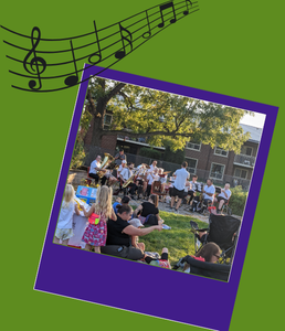 Photograph of a band sitting outside playing to people sitting on the grass