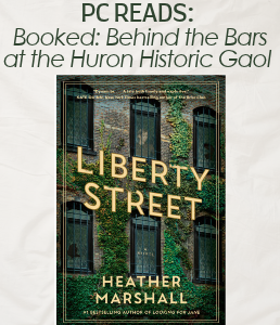 The cover of the book Liberty Street showing a close-up of a building with windows and ivy growing up the wall
