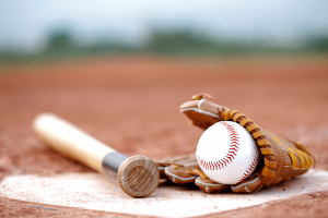 baseball glove, ball and bat lying on a base