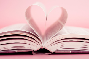 an open book where two pages are folded to form a heart