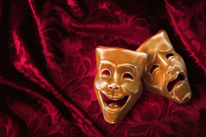 comedy and tragedy masks on a red velvet background