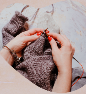 photo of hands working on knitting