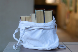 white canvas bag with books inside