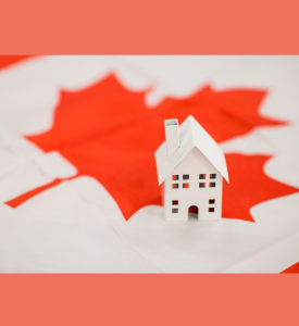 photograph of a toy house sitting on a Canadian flag