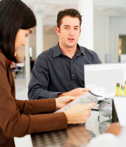 photo of a man and a woman sitting at a table with papers in their hands